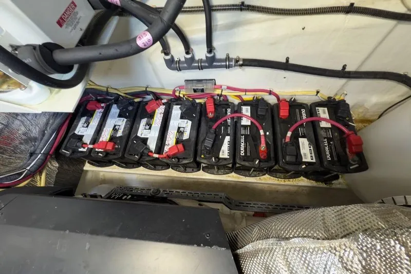 Slide: The Image of Battery compartment of 2020 Cruisers Yachts 50 Cantius with multiple Duracell batteries. - 62