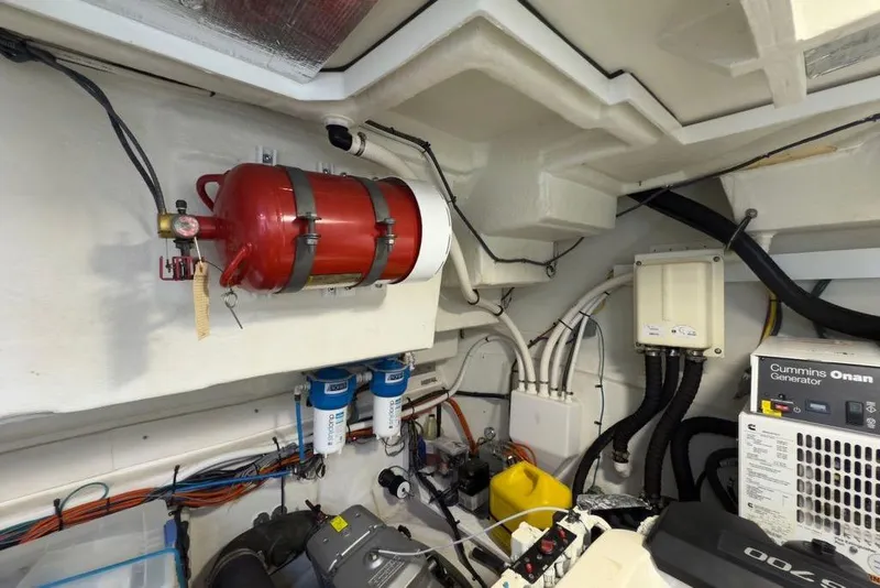 Slide: The Image of Engine room of 2020 Cruisers Yachts 50 Cantius with fire extinguisher and Cummins Onan generator. - 66