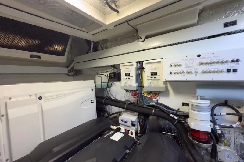 Slide: The Image of Engine room of 2020 Cruisers Yachts 50 Cantius, featuring control panels and wiring. - 67