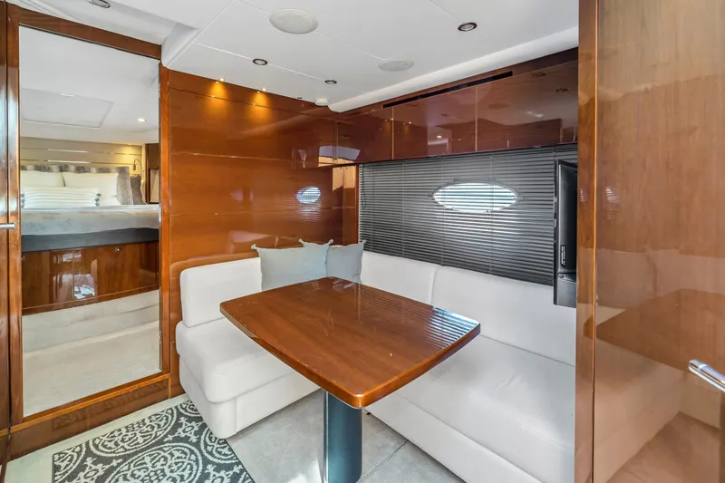 Slide: The Image of Luxurious interior of 2013 Princess V57 yacht with elegant wood finishes and cozy seating area. - 15