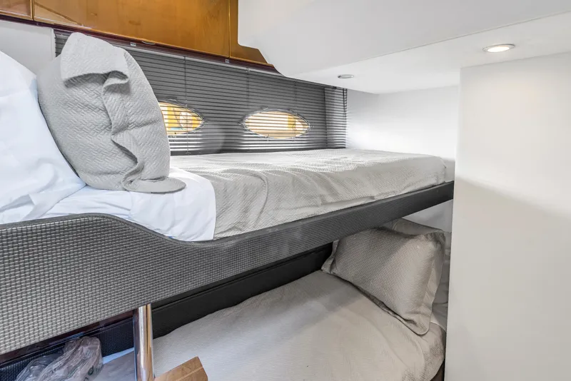 Slide: The Image of Bunk beds in 2013 Princess V57 yacht cabin with modern design and cozy bedding. - 21