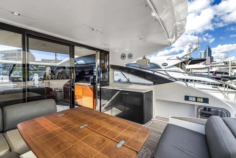 Slide: The Image of Luxurious 2013 Princess V57 yacht deck with seating and table, docked at marina. - 32