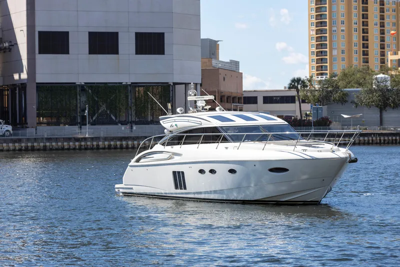 Slide: The Image of Luxurious 2013 Princess V57 yacht cruising near urban waterfront buildings. - 4
