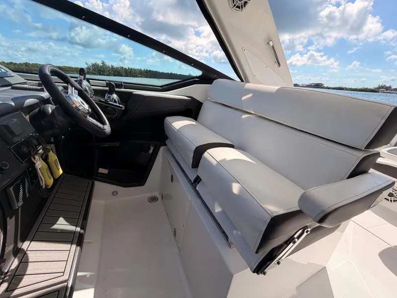 Slide: The Image of 2017 Monterey 378 Super Express boat interior with steering wheel and cushioned seating. - 16