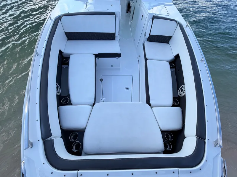 Slide: The Image of 2017 Monterey 378 Super Express boat with spacious seating, docked on calm water. - 19