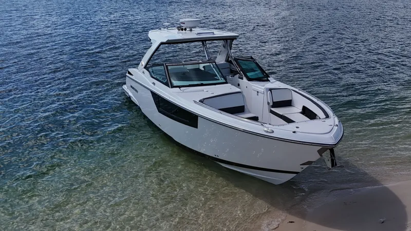 Slide: The Image of 2017 Monterey 378 Super Express boat on clear water near sandy shore. - 2
