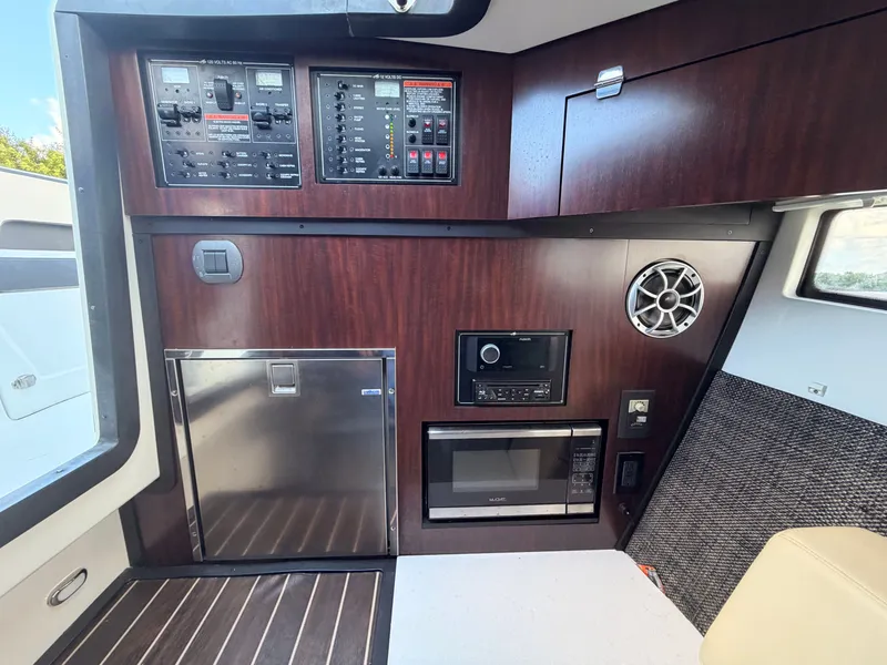 Slide: The Image of Interior of 2017 Monterey 378 Super Express with control panels, microwave, and speaker. - 21