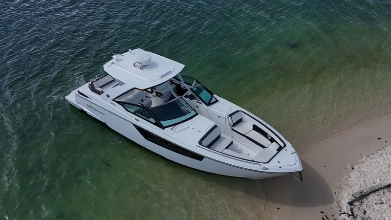 Slide: The Image of 2017 Monterey 378 Super Express boat beached on sandy shore with clear water. - 3