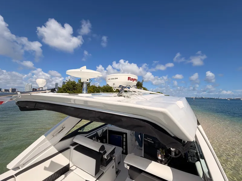 Slide: The Image of 2017 Monterey 378 Super Express yacht docked by the shore under a clear blue sky. - 8