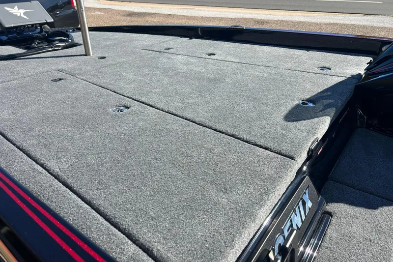 Slide: The Image of 2026 Phoenix 921 Elite X boat deck with carpeted surface and storage compartments. - 9