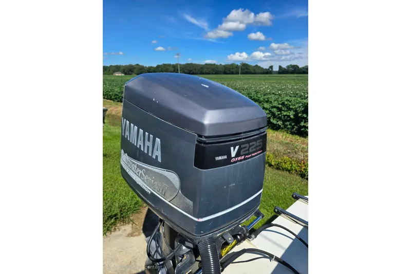 Slide: The Image of Yamaha V225 outboard motor on 1999 Sport-Craft 230 boat, with scenic countryside backdrop. - 16