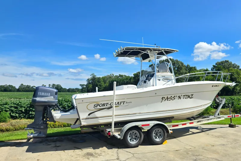 Slide: The Image of 1999 Sport-Craft 230 boat on trailer with Yamaha outboard motor, parked outdoors. - 5