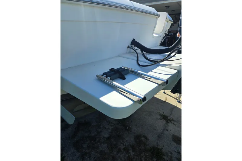 Slide: The Image of 1999 Sport-Craft 230 boat with a foldable swim ladder on the stern. - 7