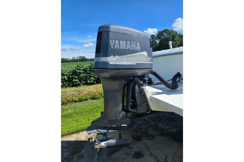 Slide: The Image of Yamaha outboard motor on 1999 Sport-Craft 230 boat, sunny outdoor setting. - 8