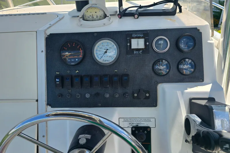 Slide: The Image of Dashboard of a 1999 Sport-Craft 230 boat with gauges and controls. - 9