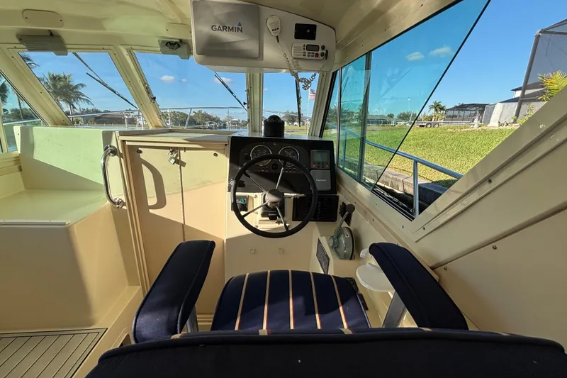 Slide: The Image of Interior of 2001 Albin 28 Tournament Express boat with steering wheel and Garmin equipment. - 12