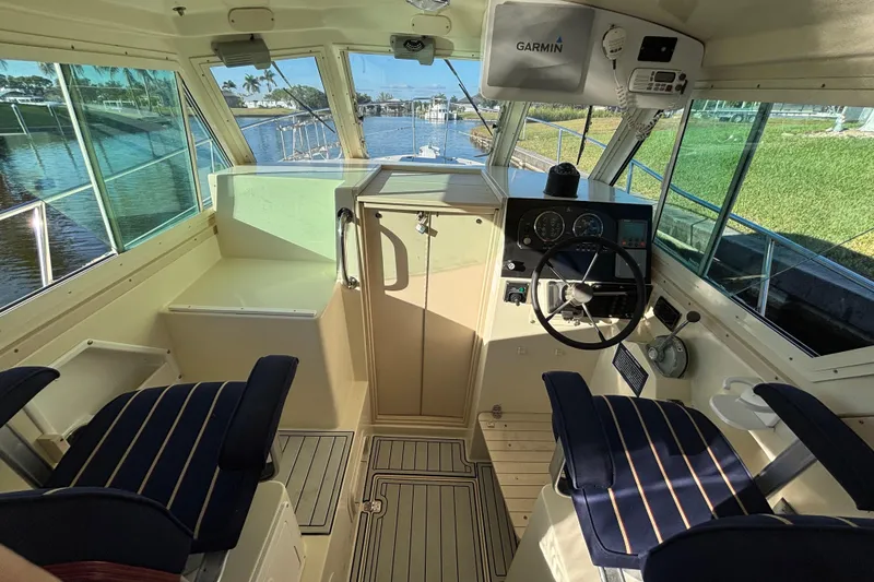 Slide: The Image of Interior of 2001 Albin 28 Tournament Express boat with steering wheel and seating. - 13