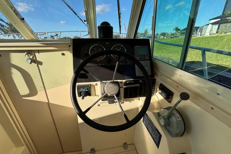 Slide: The Image of Helm of 2001 Albin 28 Tournament Express boat with steering wheel and control panel. - 14