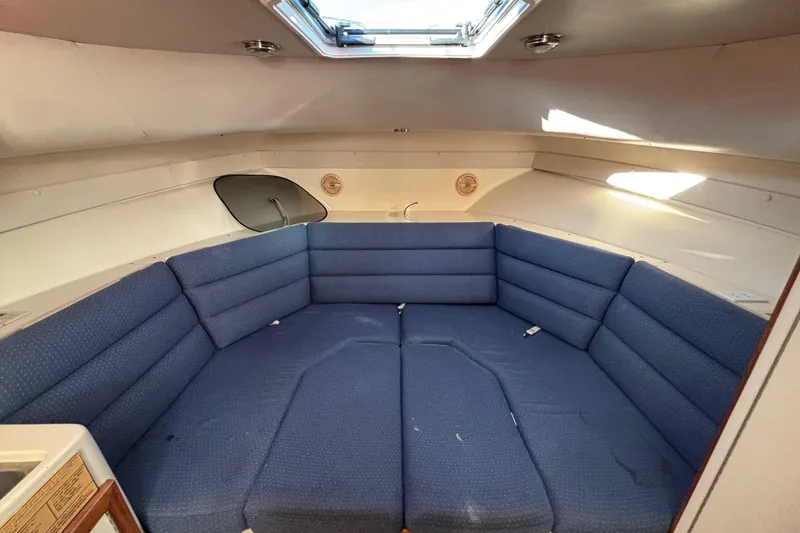 Slide: The Image of Interior of 2001 Albin 28 Tournament Express with blue cushioned seating and overhead hatch. - 20