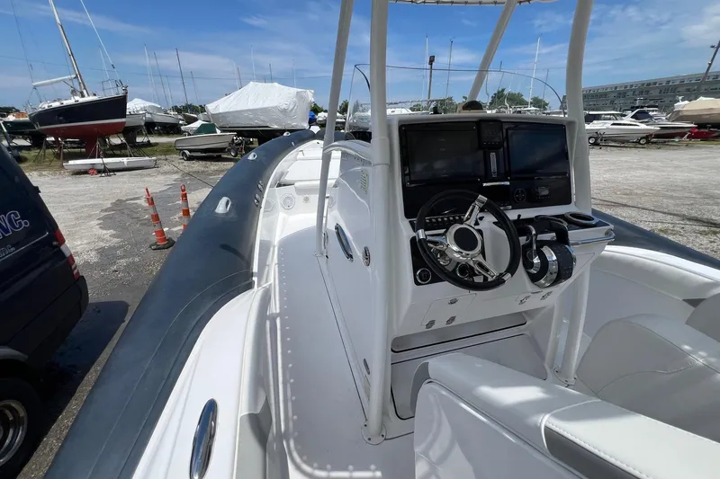 Slide: The Image of Airship 330 boat cockpit with steering wheel and controls, docked in a marina, 2015 model. - 13