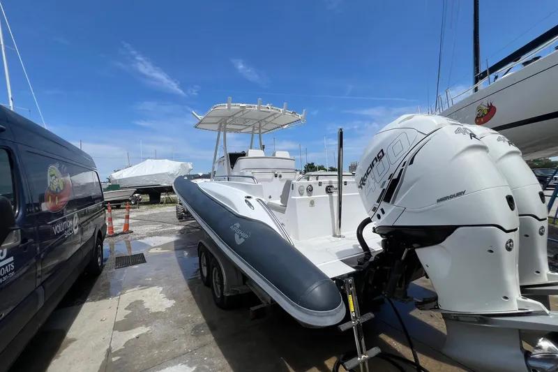 Slide: The Image of 2015 Airship 330 boat with dual Mercury Racing 400 engines at a marina. - 2
