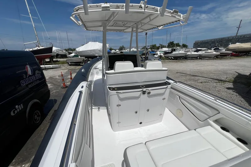 Slide: The Image of 2015 Airship 330 boat with seating and storage, docked in a marina under a clear sky. - 6