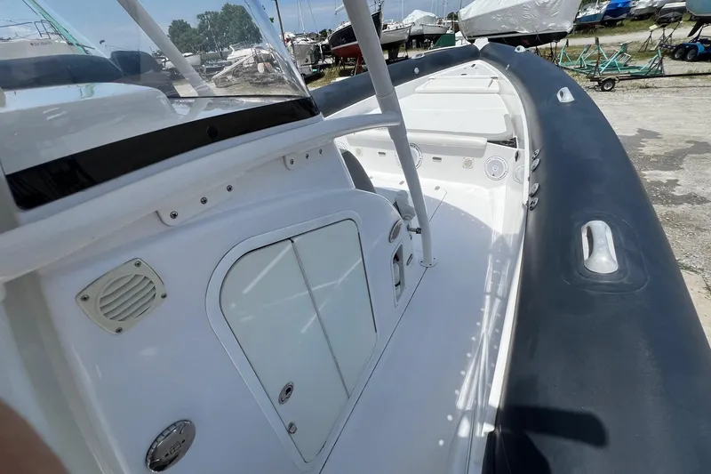 Slide: The Image of 2015 Airship 330 boat interior with white console and black inflatable sides. - 8