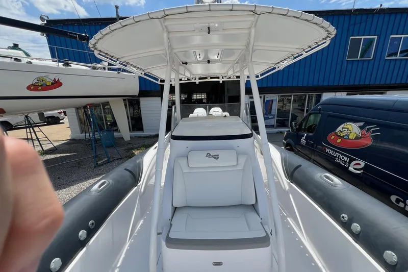 Slide: The Image of 2015 Airship 330 boat with canopy, docked near blue building and van. - 9