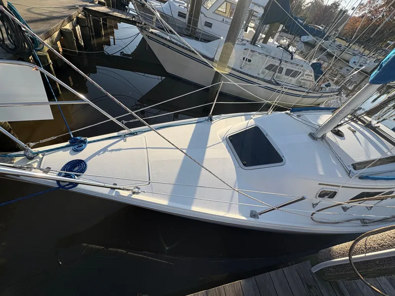 Slide: The Image of 1988 Catalina 27 sailboat docked at marina. - 13