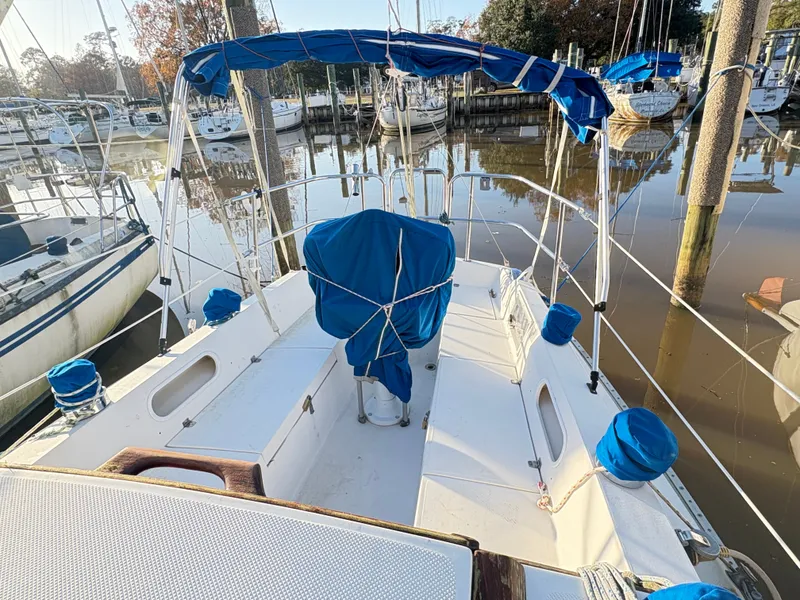 Slide: The Image of 1988 Catalina 27 sailboat docked with blue covers. - 16