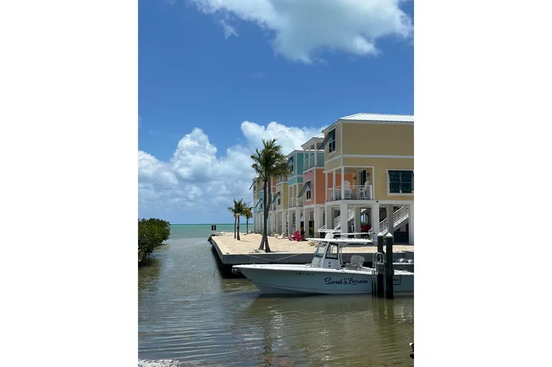 Slide: The Image of Coastal scene with Sea Hunt Gamefish 30 boat near colorful waterfront buildings. - 13
