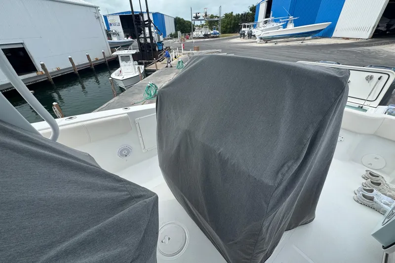 Slide: The Image of 2021 Sea Hunt Gamefish 30 Coffin Box boat with covered seating, dockside view. - 28