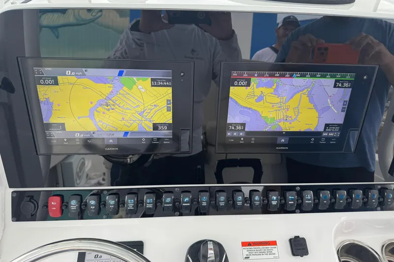 Slide: The Image of 2021 Sea Hunt Gamefish 30 dashboard with dual Garmin navigation displays. - 33