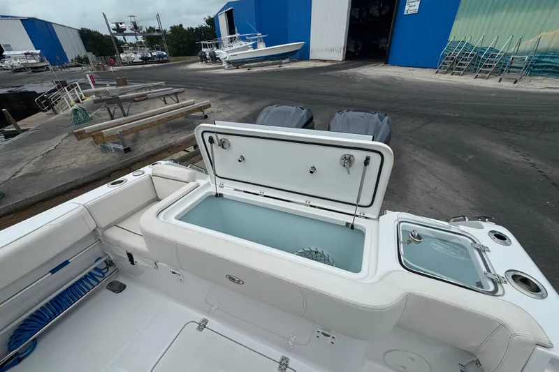 Slide: The Image of 2021 Sea Hunt Gamefish 30 Coffin Box boat with open storage compartment at marina. - 35