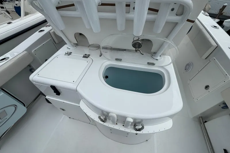 Slide: The Image of 2021 Sea Hunt Gamefish 30 Coffin Box boat interior with livewell and storage compartments. - 37