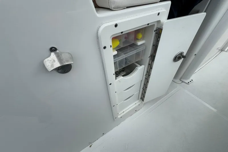 Slide: The Image of Storage compartment on 2021 Sea Hunt Gamefish 30 Coffin Box boat, featuring organized drawers. - 39
