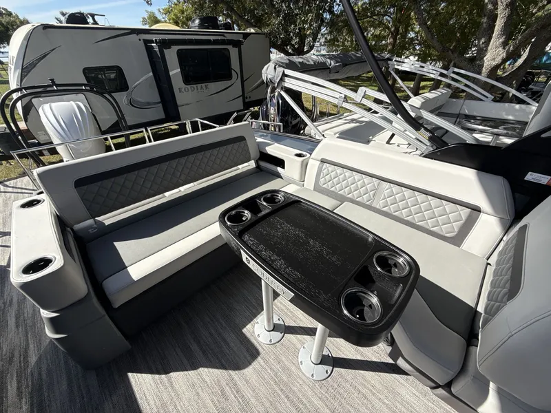 Slide: The Image of Godfrey 255 SFL 2026 pontoon boat with Yamaha engine in showroom. - 11