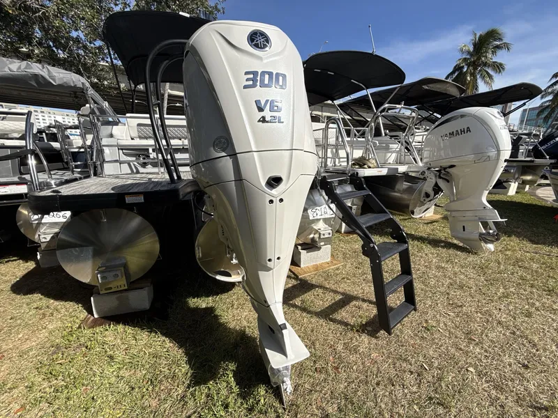 Slide: The Image of 2026 Godfrey 255 SFL pontoon boat in showroom with Yamaha engine. - 13
