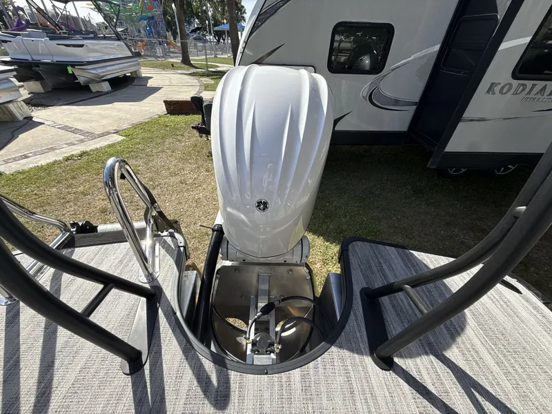 Slide: The Image of Godfrey 255 SFL 2026 pontoon boat with Yamaha engine in showroom. - 14