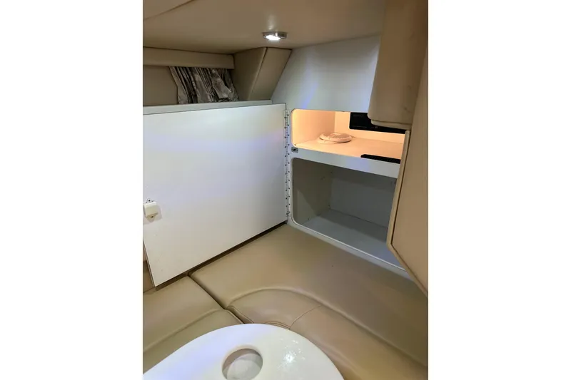 Slide: The Image of 1997 Formula 41 Performance Cruiser interior with open storage compartment and beige seating. - 14