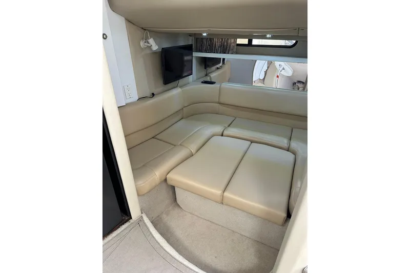 Slide: The Image of 1997 Formula 41 Performance Cruiser interior with beige leather seating and mounted TV. - 15