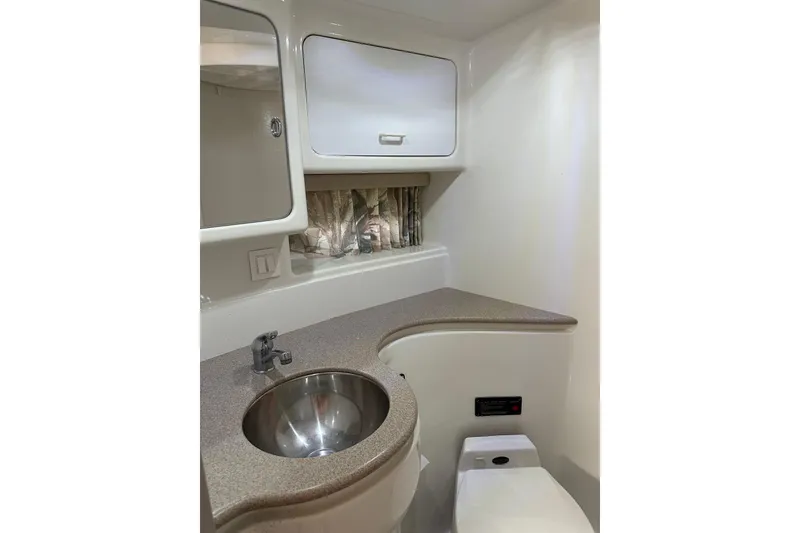 Slide: The Image of 1997 Formula 41 Performance Cruiser bathroom with sink, mirror, and storage cabinet. - 16
