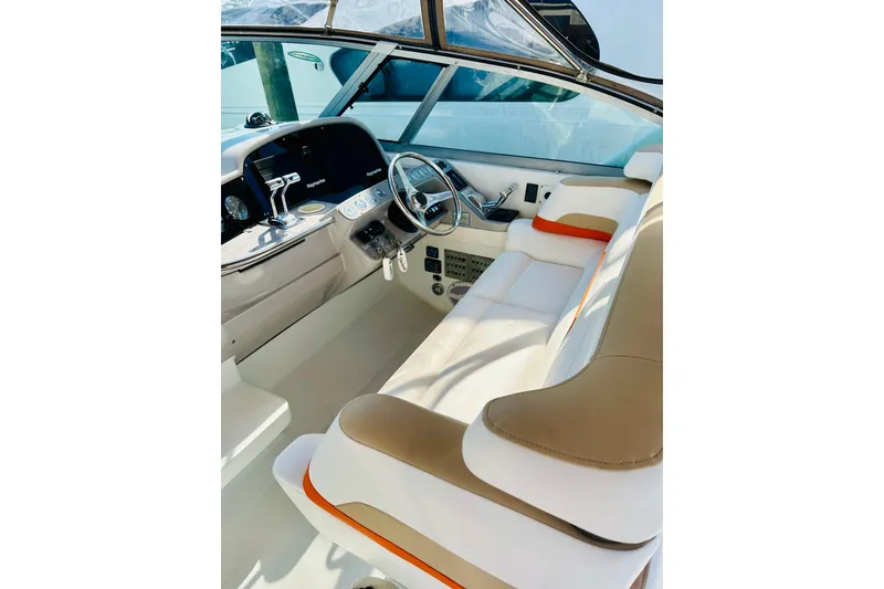 Slide: The Image of 1997 Formula 41 Performance Cruiser cockpit with beige and white seating, modern controls, and steering wheel. - 2