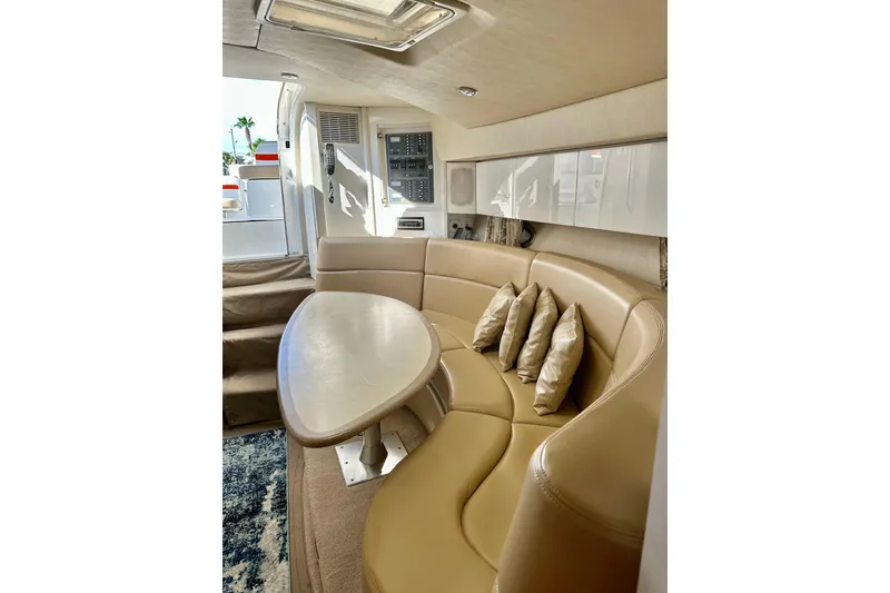 Slide: The Image of Luxurious interior of 1997 Formula 41 Performance Cruiser with beige leather seating and table. - 22