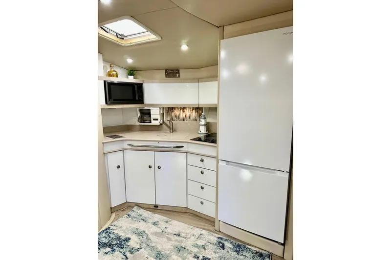 Slide: The Image of Modern kitchen in 1997 Formula 41 Performance Cruiser with white cabinetry and appliances. - 23