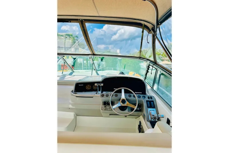 Slide: The Image of 1997 Formula 41 Performance Cruiser helm with steering wheel and navigation controls. - 3