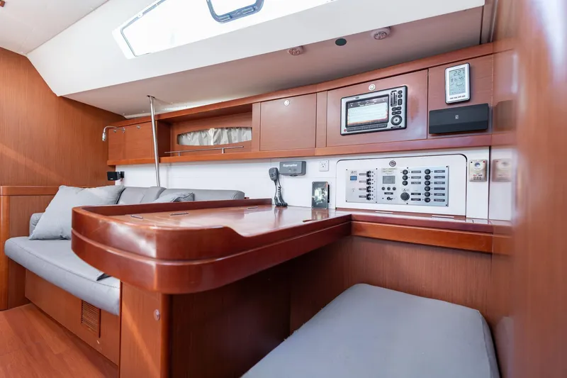 Slide: The Image of Interior of 2013 Beneteau Oceanis 50 yacht with navigation station and seating area. - 10