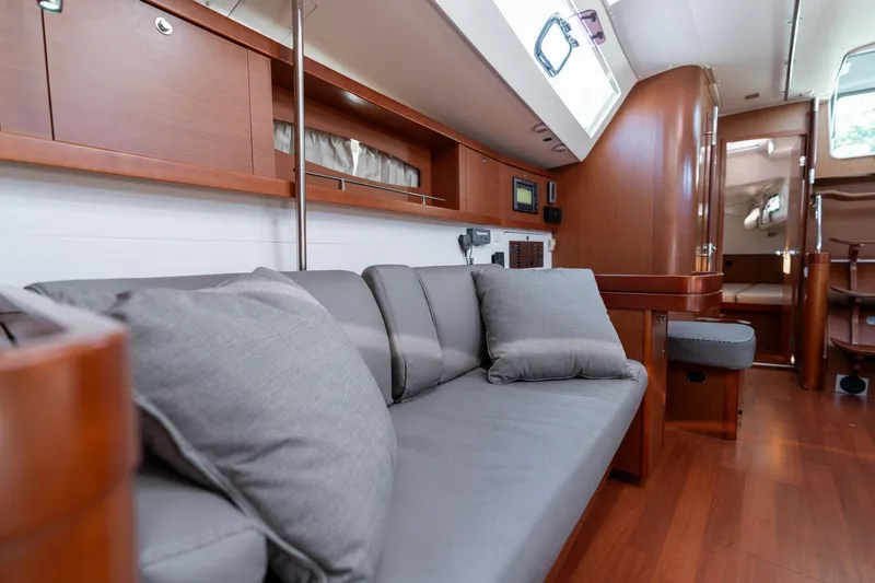 Slide: The Image of Interior of 2013 Beneteau Oceanis 50 yacht with modern wood finish and gray seating. - 12