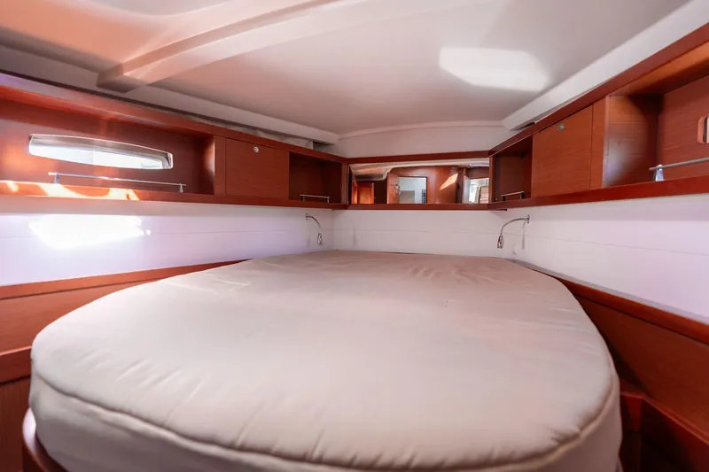 Slide: The Image of Luxurious cabin interior of 2013 Beneteau Oceanis 50 yacht with cozy bed and wooden finish. - 13