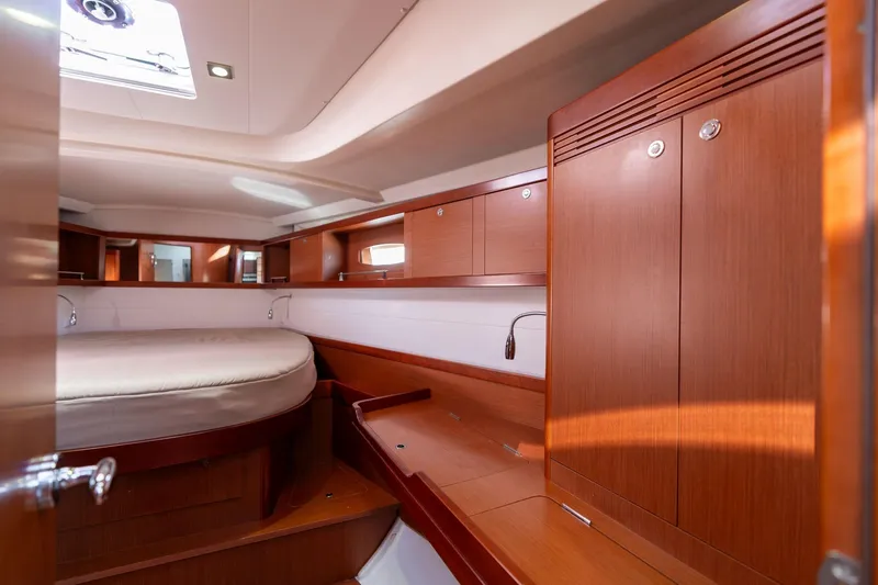 Slide: The Image of Luxurious interior of 2013 Beneteau Oceanis 50 yacht with wooden cabinetry and cozy bed. - 15
